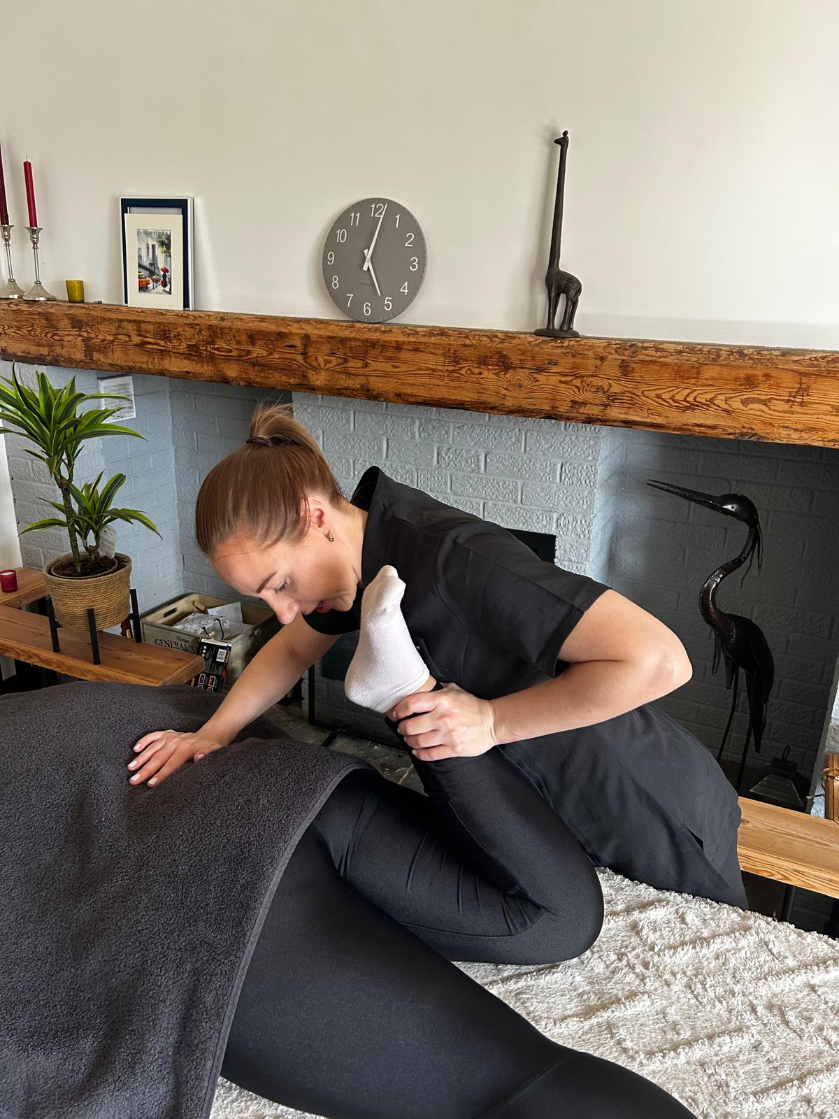 UVU Performance Lab therapist providing a targeted leg massage treatment in Westbury